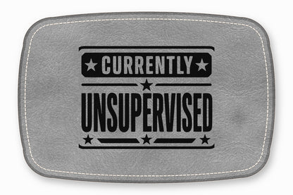 A gray leather patch with white stitched borders features the black text CURRENTLY UNSUPERVISED and stars.