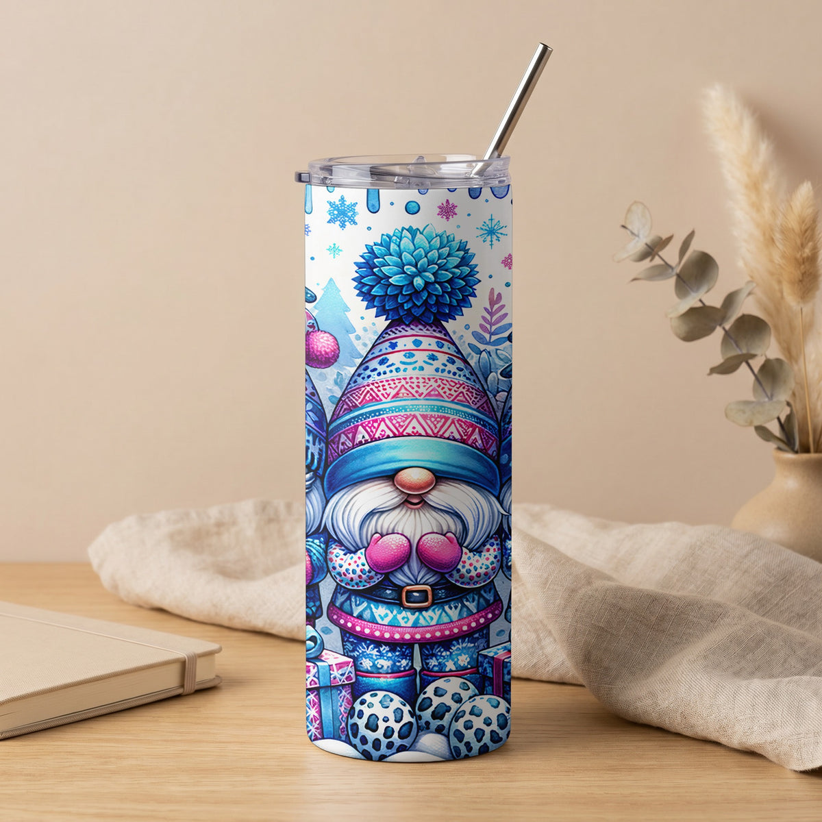 Tumbler with cheerful gnome and snowflake design, featuring blue and pink festive patterns.