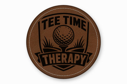 Round brown leather patch with white stitched border, featuring a black golf graphic and the text TEE TIME THERAPY.