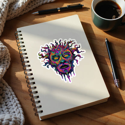 Psychedelic sun face sticker on a spiral-bound notebook.