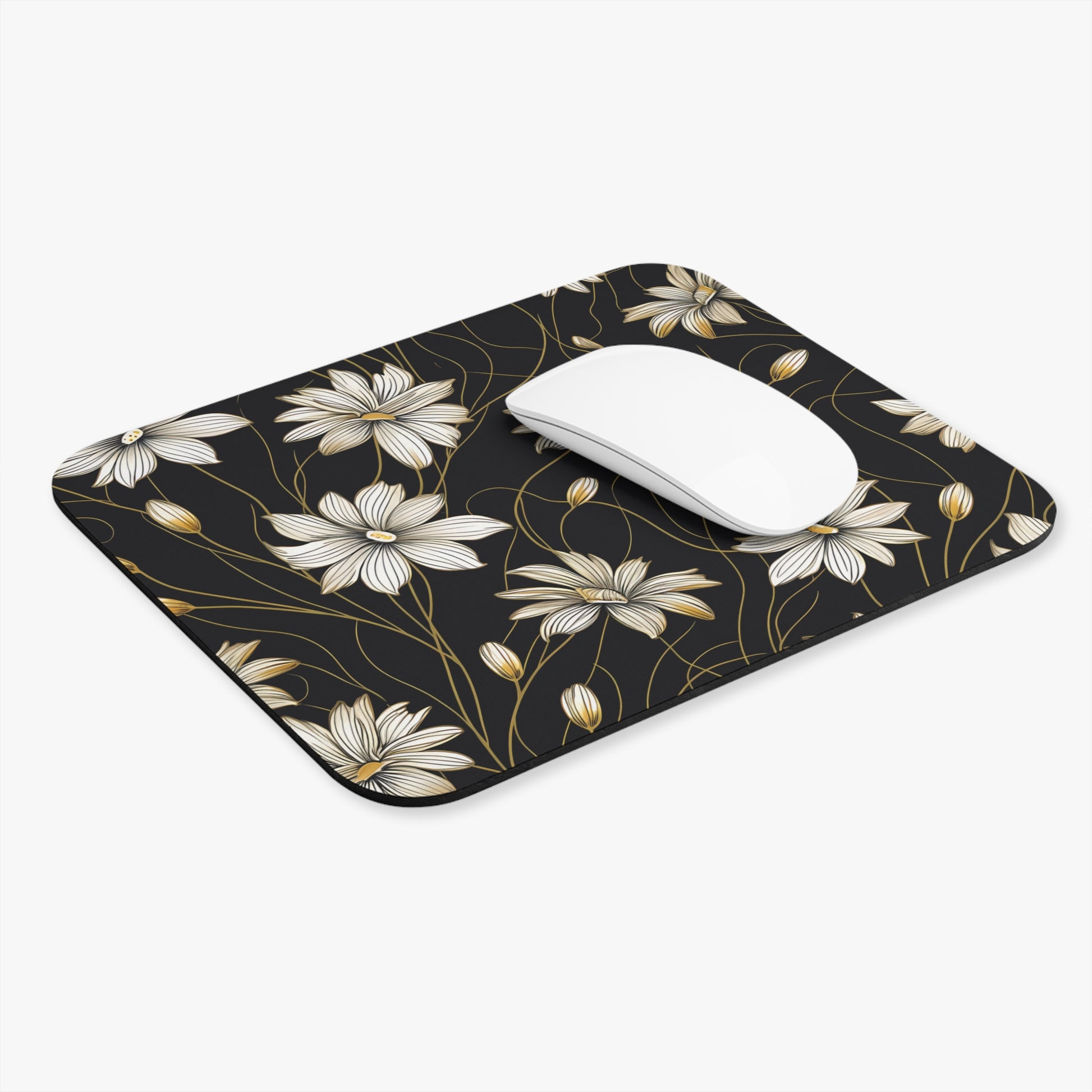 Black mousepad with white and gold floral pattern and white mouse.