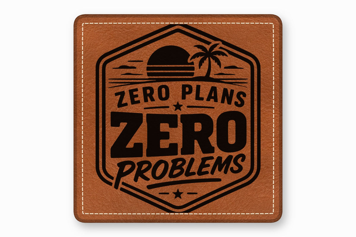 Brown square leather patch with white stitched borders and a black tropical sunset emblem and the text "ZERO PLANS ZERO PROBLEMS".