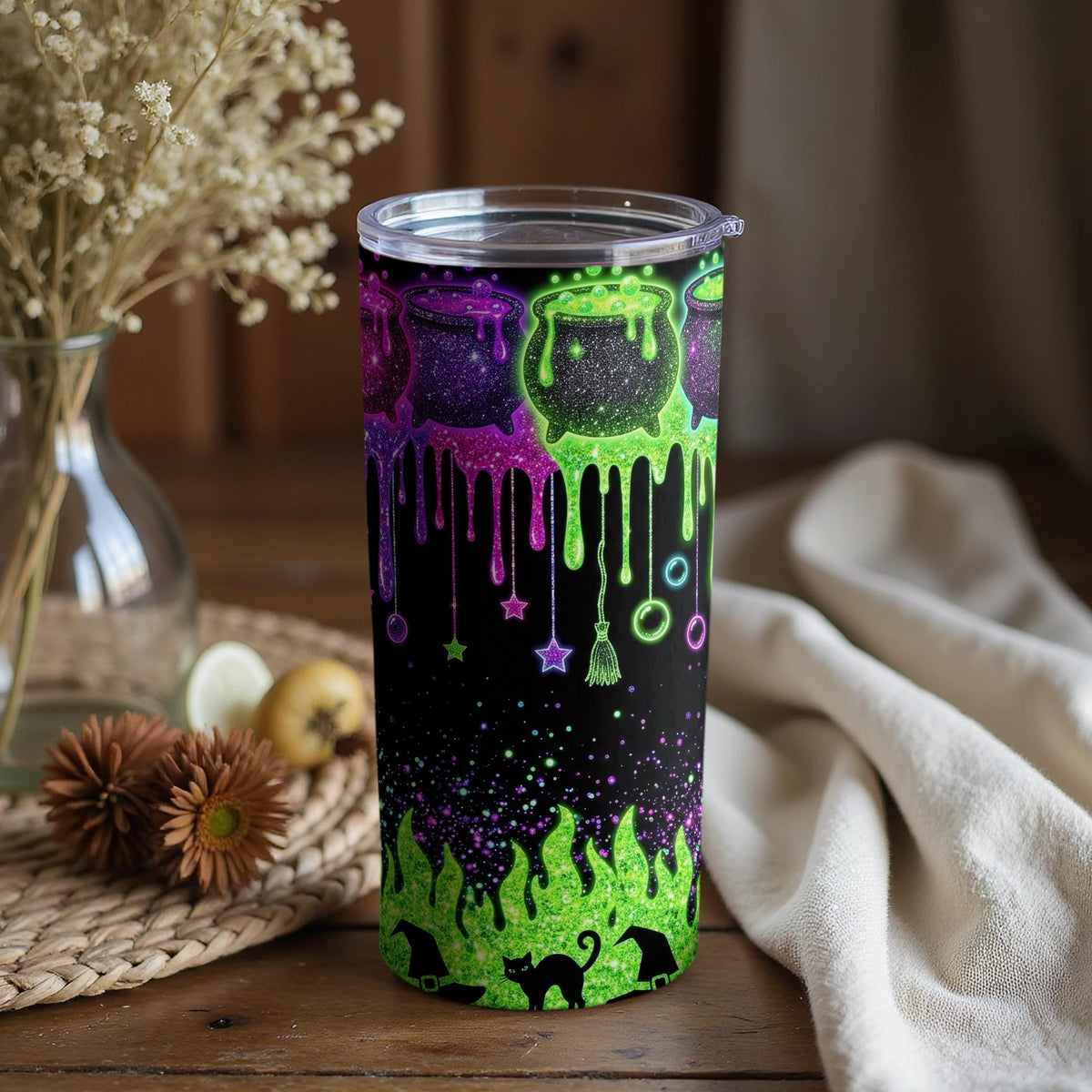 Black tumbler with Halloween cauldron, witch hats, black cat, and starry drips.