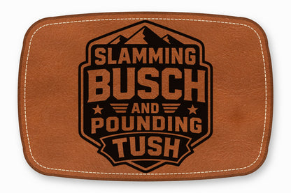 Brown leather patch with white stitching featuring black text that reads Slamming Busch and Pounding Tush.
