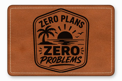 Brown rectangular leather patch embossed with a sunset, palm tree, and text reading ZERO PLANS ZERO PROBLEMS.