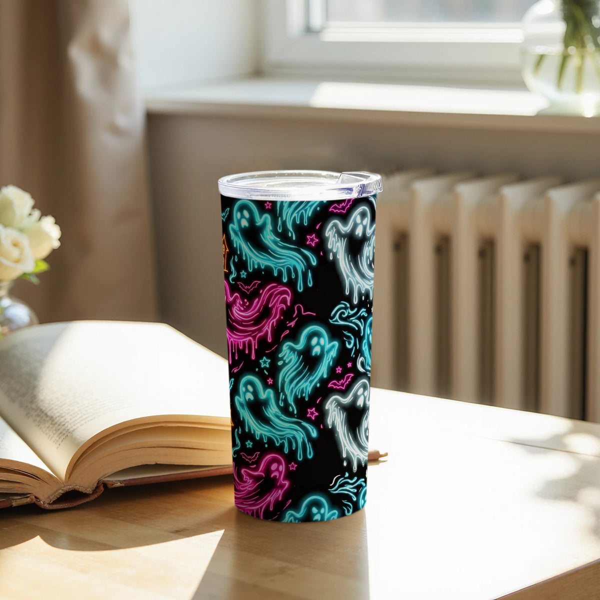 Tumbler with black background and neon ghost, bat, and star pattern.
