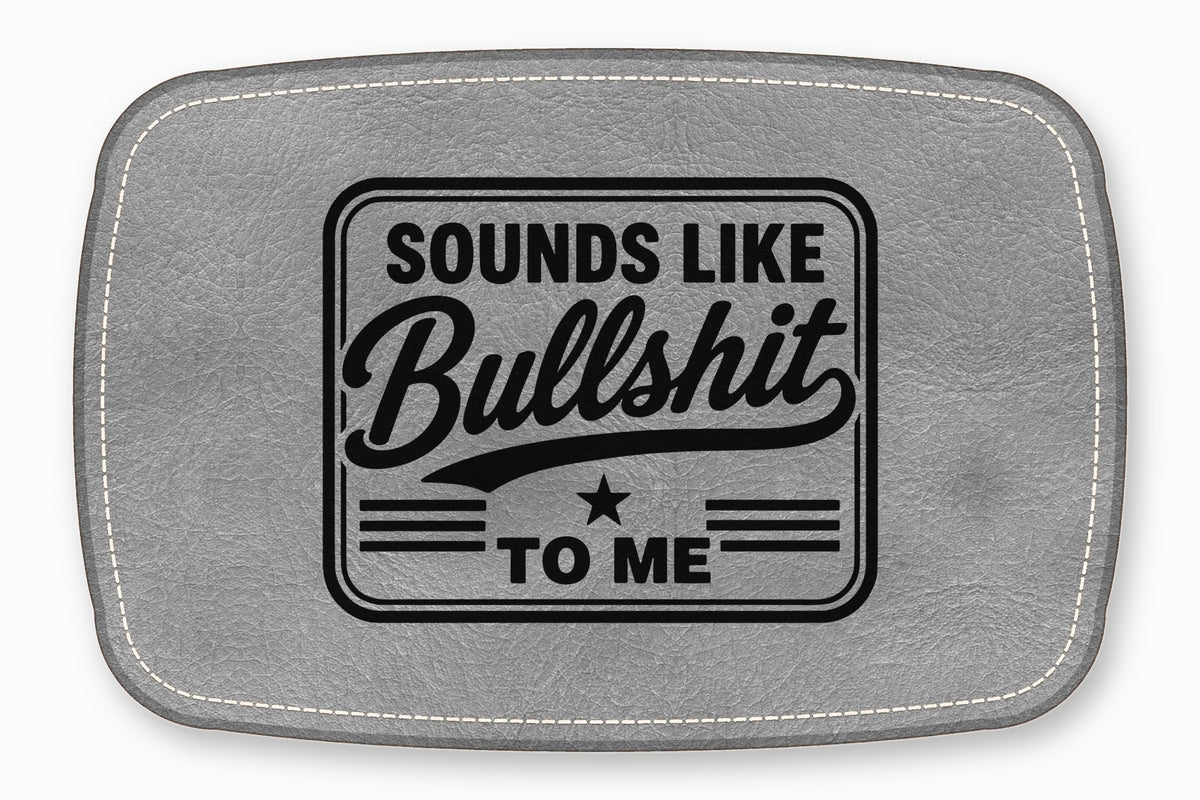 A rectangular grey leather patch with white stitching featuring the black text Sounds Like Bullshit To Me.