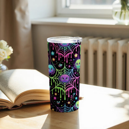 Tumbler with colorful cartoon spiders, stars, and dripping slime on a black background.