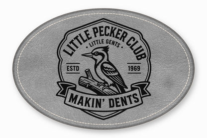 Grey oval faux leather patch featuring a black embroidered emblem of a woodpecker, text, and stitched border.