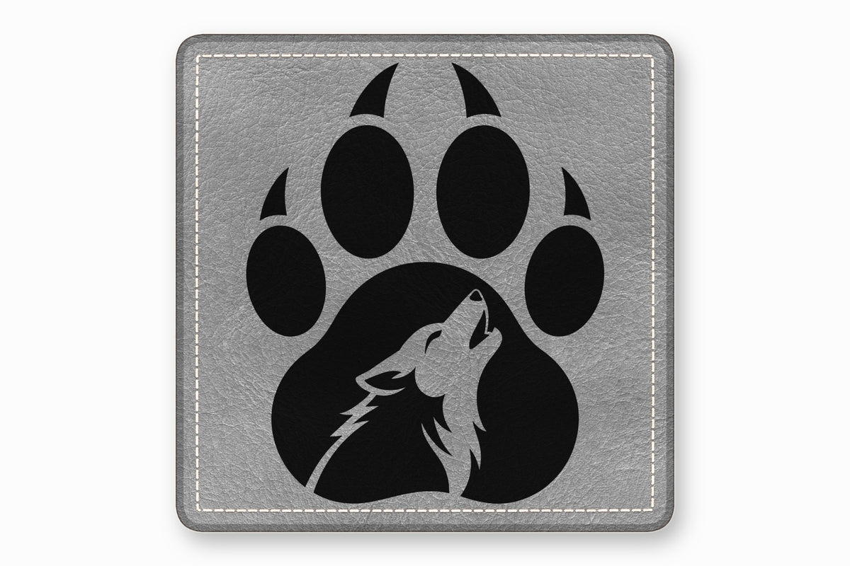 Square grey leather patch featuring a black paw print with a howling wolf silhouette inside.