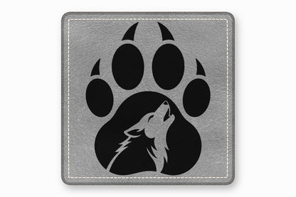 Square grey leather patch featuring a black paw print with a howling wolf silhouette inside.
