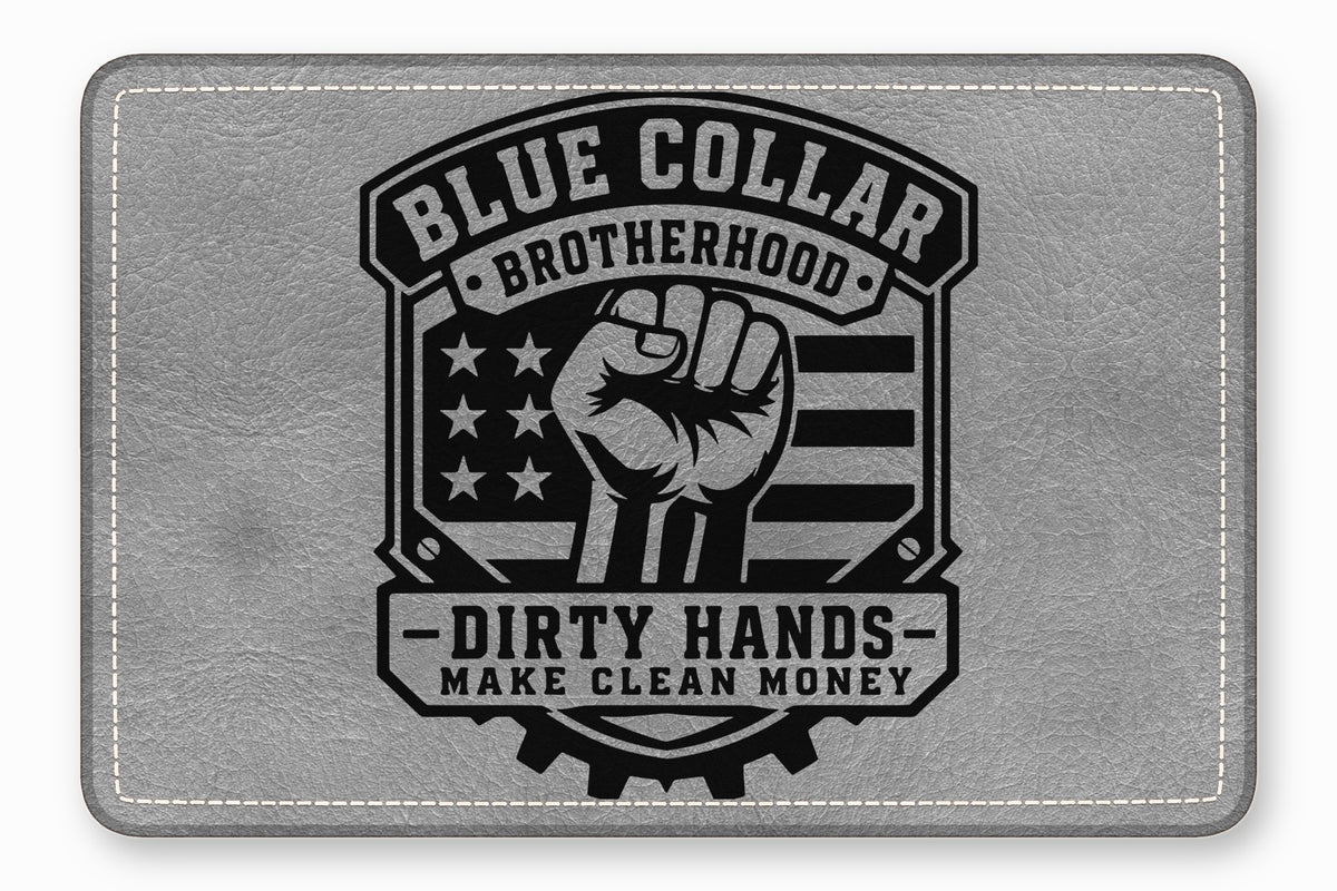 A gray leather rectangle with rounded corners features a black embossed design depicting a raised fist, American flag elements, and text reading Blue Collar Brotherhood, Dirty Hands, Make Clean Money.