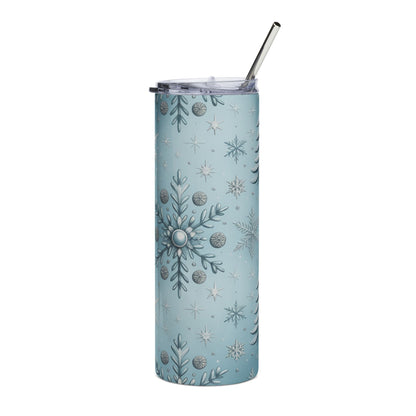 Light blue tumbler with a winter snowflake and pine tree pattern and a metal straw.
