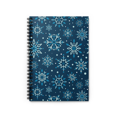 Spiral-bound notebook with dark blue cover and scattered snowflake pattern.