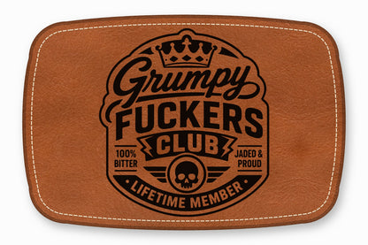 Brown leather rectangular patch with white stitched borders and a black Grumpy Fuckers Club logo.