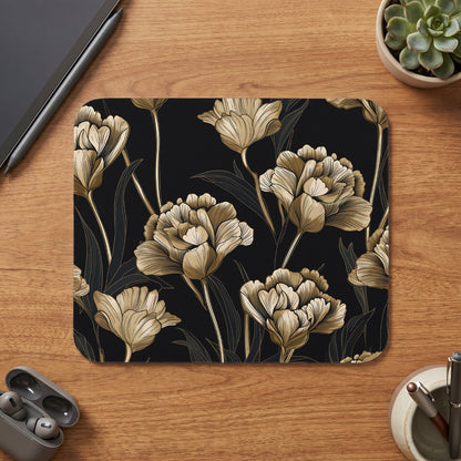 Mousepad with golden floral pattern on black background.