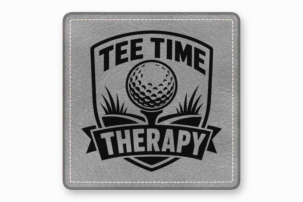 A square grey faux leather patch with white stitched borders and a black golf-themed design reading Tee Time Therapy.