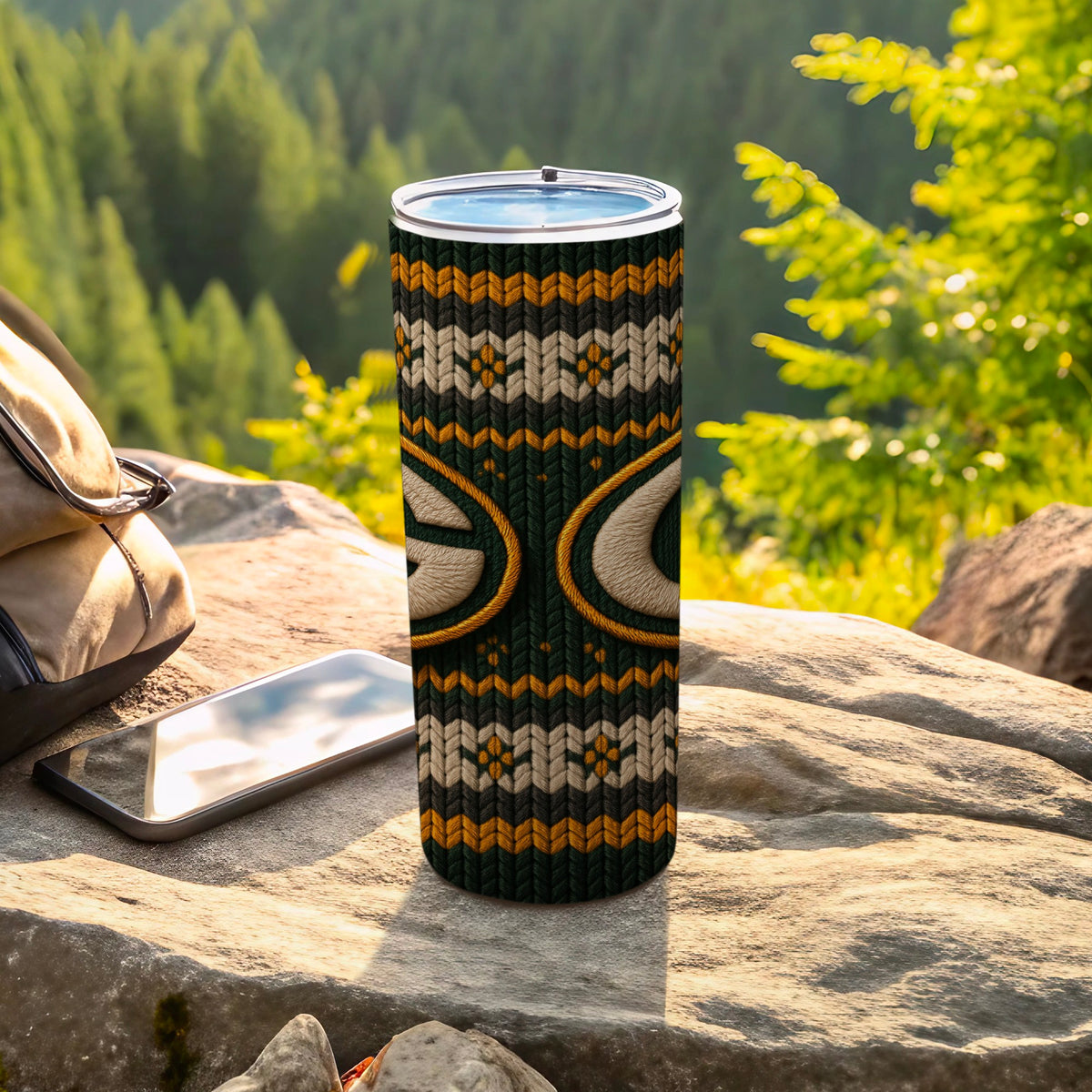 Green Bay Packers tumbler with a knitted pattern and logo on a rock.