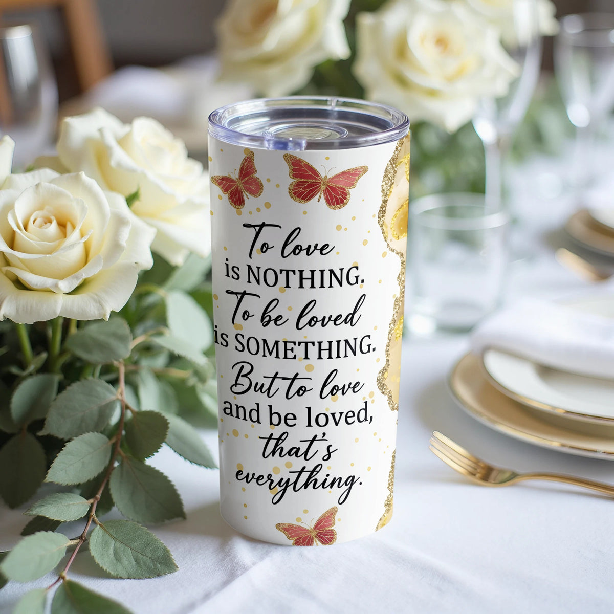 Tumbler with red butterflies and gold glitter, featuring the quote "To love is nothing. To be loved is something. But to love and be loved, that's everything."