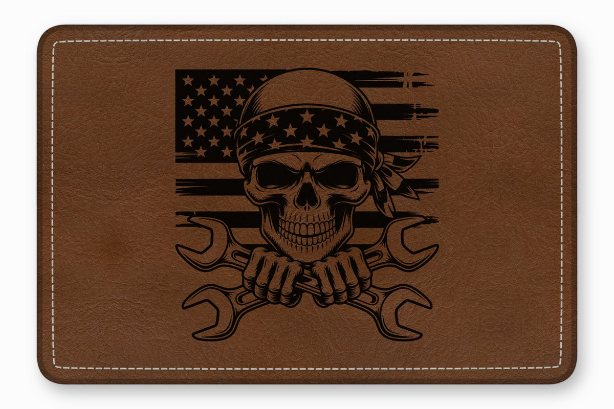 Brown leather patch laser-engraved with a skull wearing a bandana over a distressed American flag and crossed wrenches.