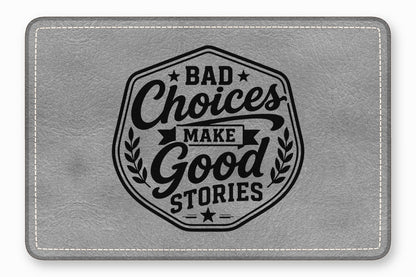 A gray faux leather patch with white stitching and the text BAD CHOICES MAKE GOOD STORIES.