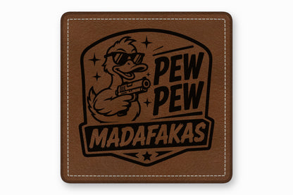 A brown leather square patch features a laser-engraved design of a duck wearing sunglasses and holding a gun, with the text PEW PEW MADAFAKAS.