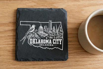 Square black slate coaster engraved with an Oklahoma City skyline and the text OKLAHOMA CITY OKLAHOMA.