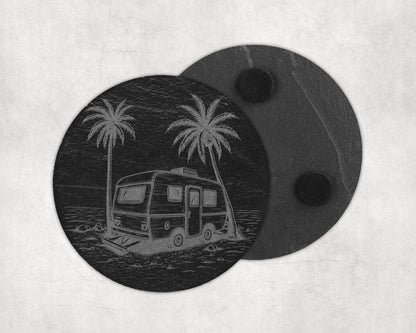 Round slate coaster etched with a vintage camper and palm trees on a beach.