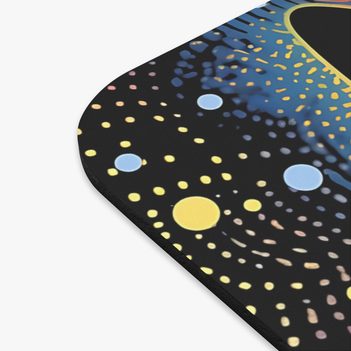 Close-up of a rounded black mousepad featuring an abstract whale shark pattern with yellow and blue dots.