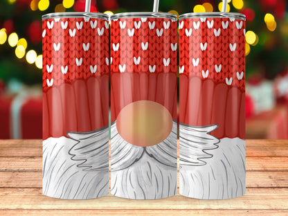 Three tumblers with a red knitted pattern and gnome faces on a wooden table.