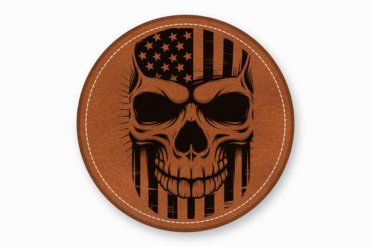 A round brown leather patch with white stitched edges features a black engraved skull and American flag design.