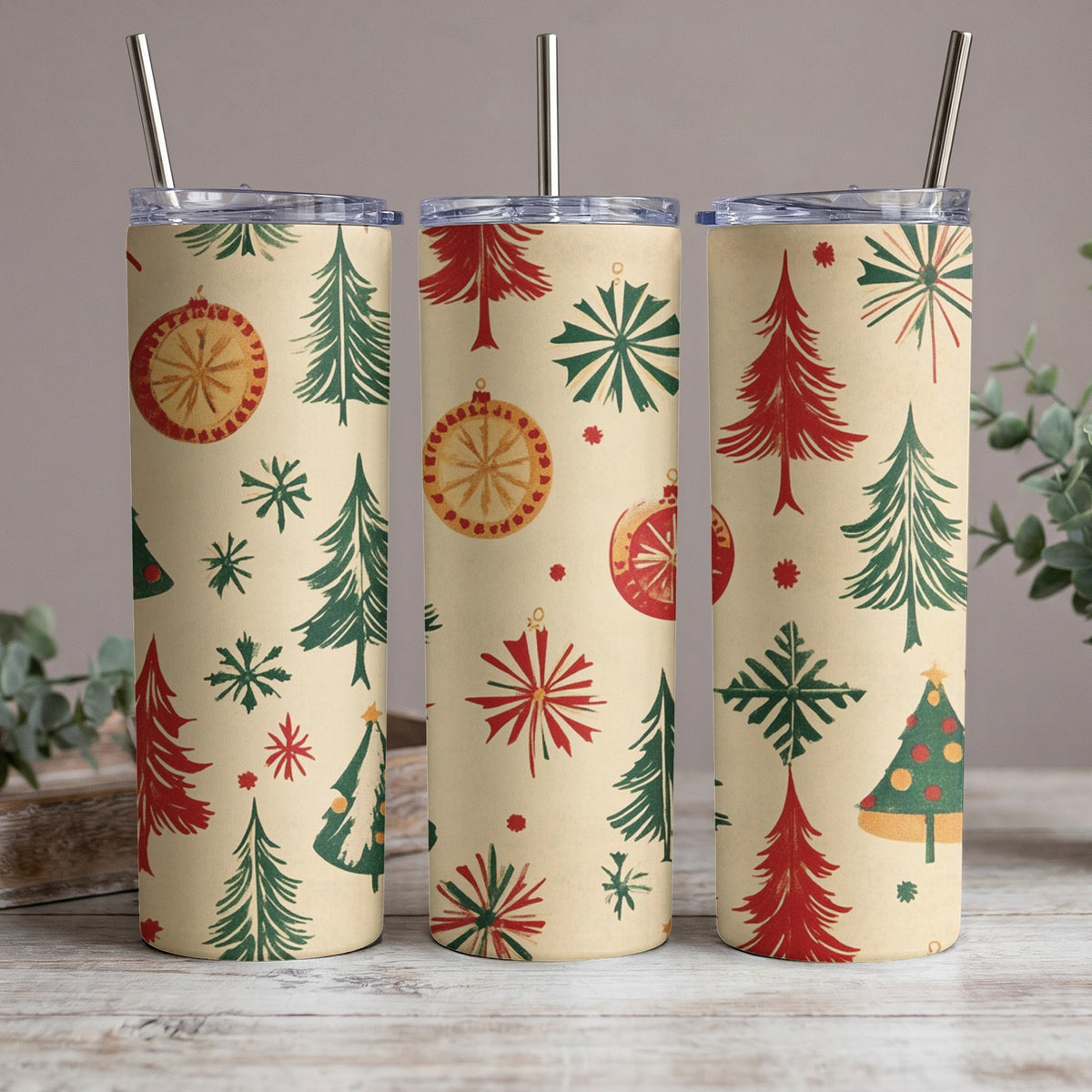 Three tumblers with a retro Christmas pattern of trees, ornaments, and snowflakes.