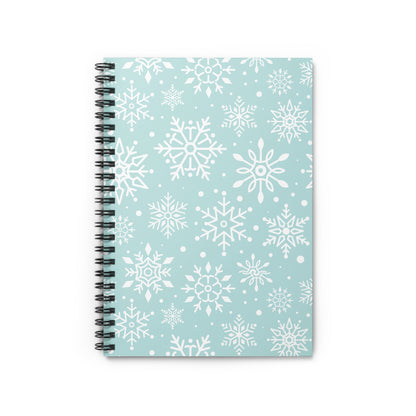 Spiral-bound notebook with a light blue cover patterned with white snowflakes.