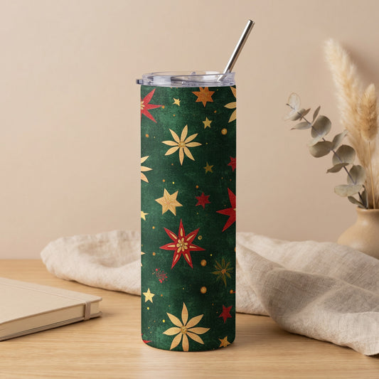 Green tumbler with red and gold star and floral Christmas pattern and metal straw.