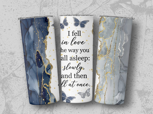 Tumblers with marbled blue, gray, and gold designs and "I fell in love" quote.