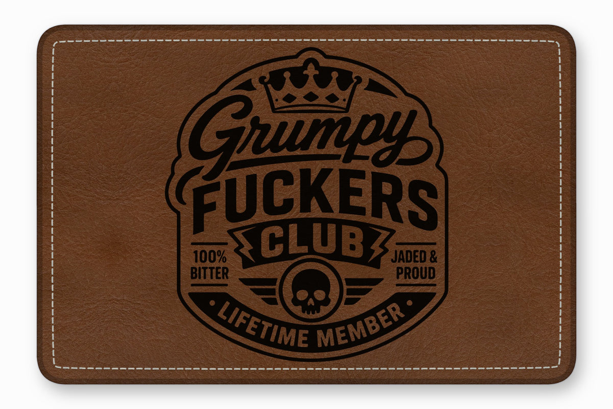 Brown leather patch with white stitching and a black debossed logo that reads Grumpy Fuckers Club.