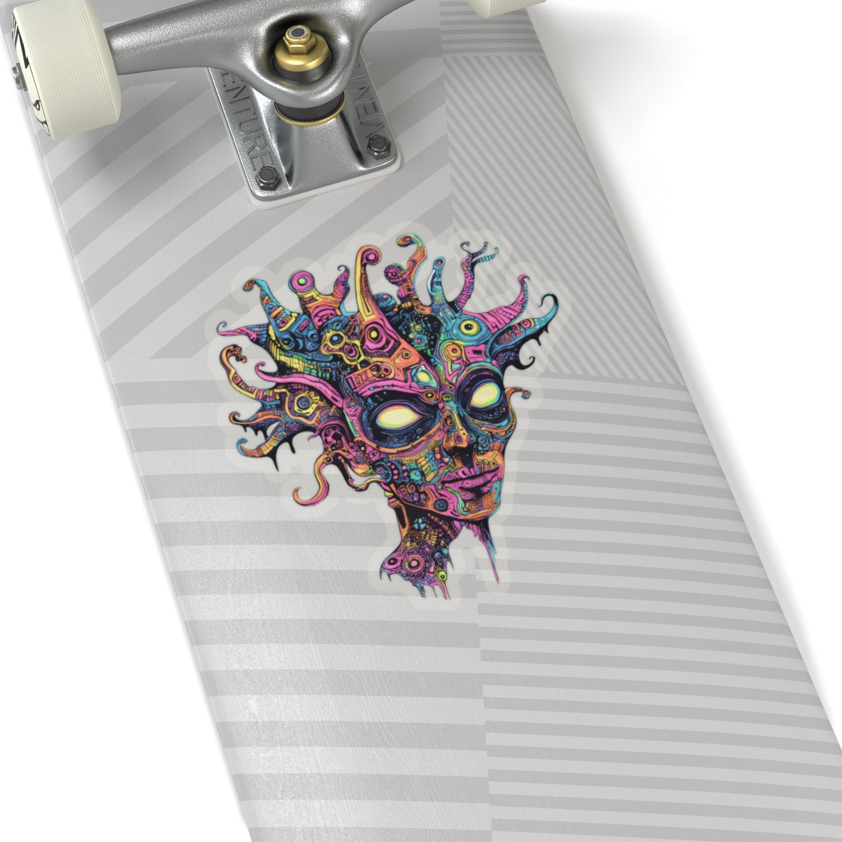 Colorful, abstract alien face sticker on a skateboard with silver truck.