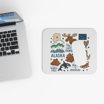 Mousepad with Alaska illustrations: moose, bear, orca, mountains, and text.