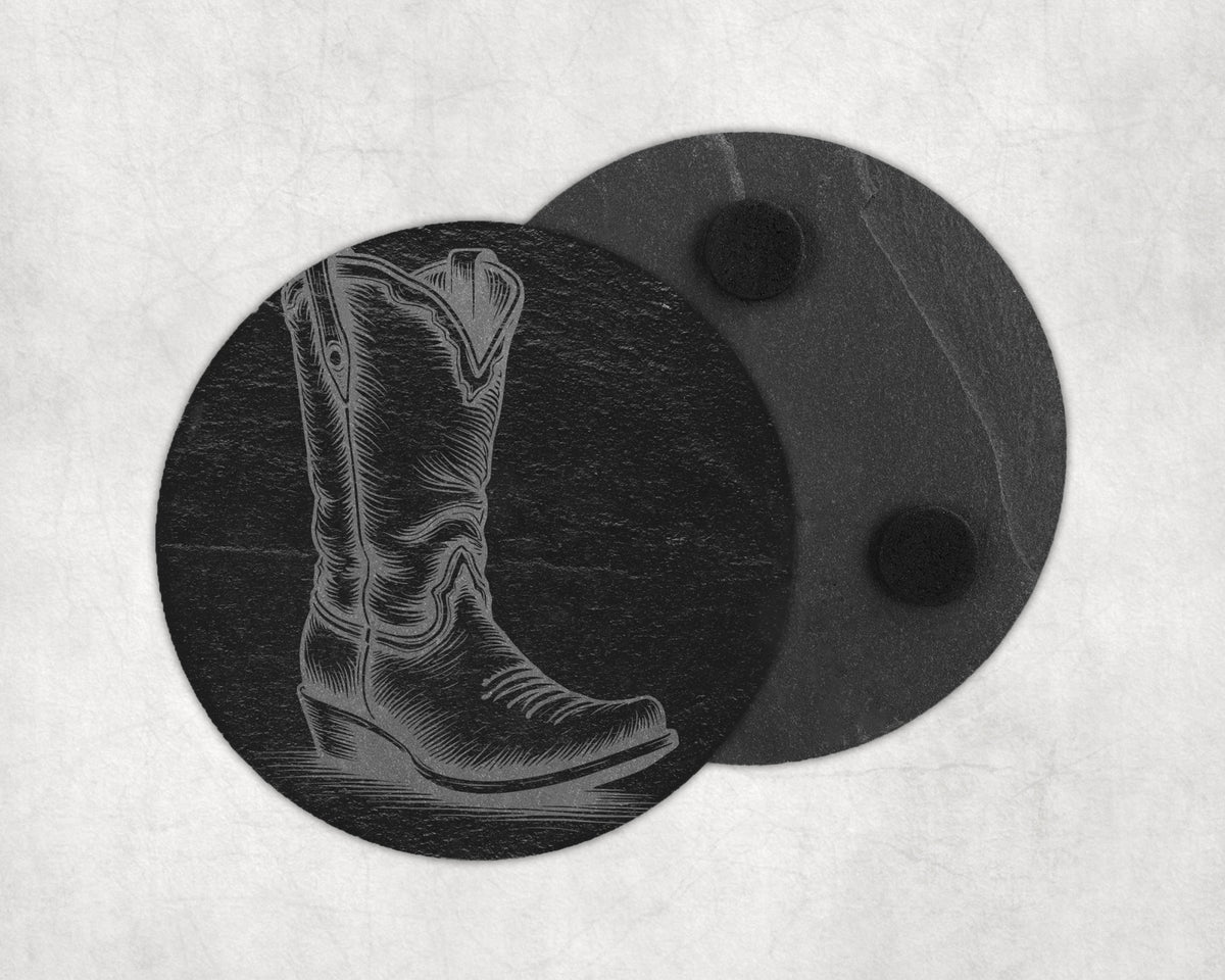 Round slate coaster etched with a cowboy boot design next to another coaster.
