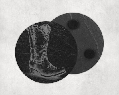 Round slate coaster etched with a cowboy boot design next to another coaster.