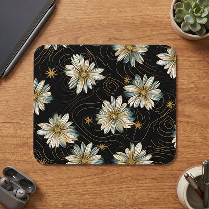 Black mousepad with white, blue, and gold floral pattern and swirling lines.