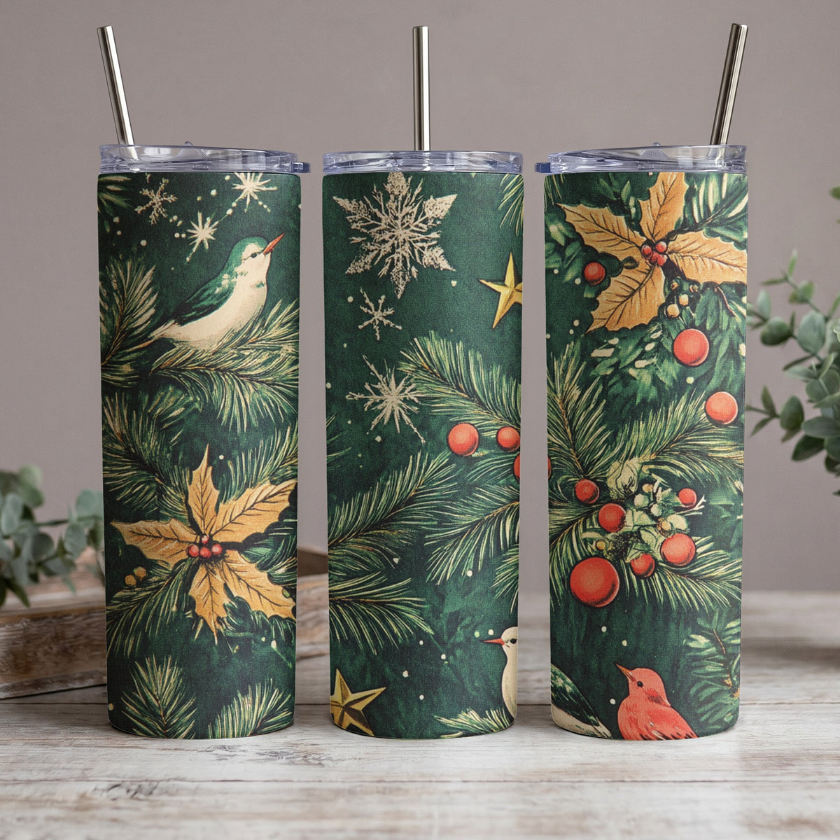 Three tumblers with a vintage Christmas design of birds, holly, and snowflakes.
