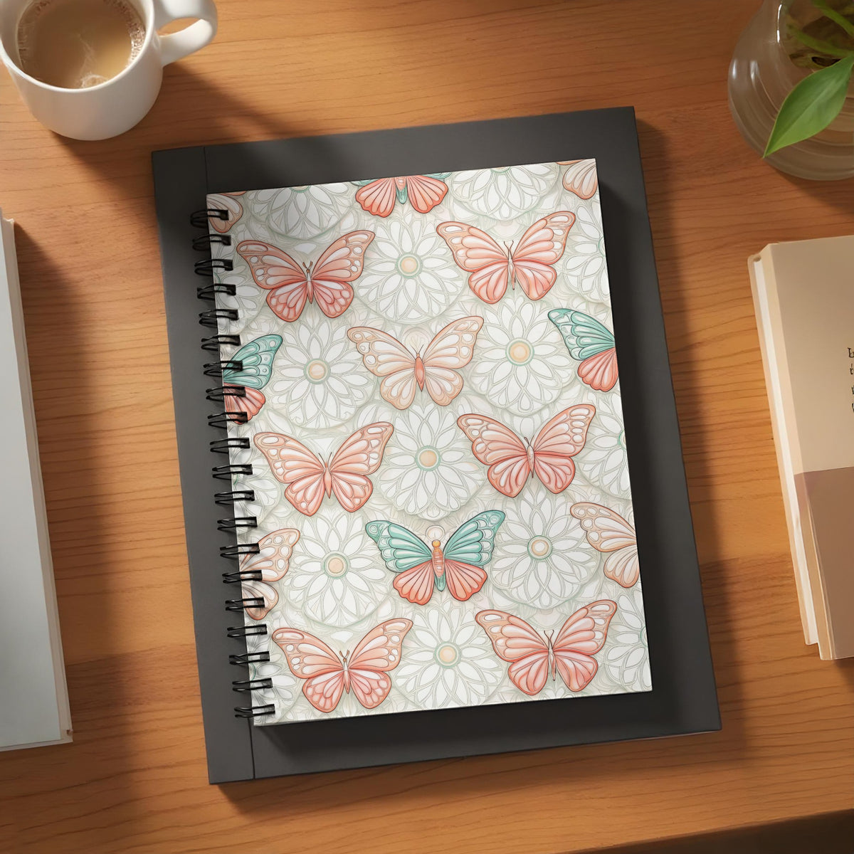 Spiral notebook with coral and teal butterflies on a floral pattern.