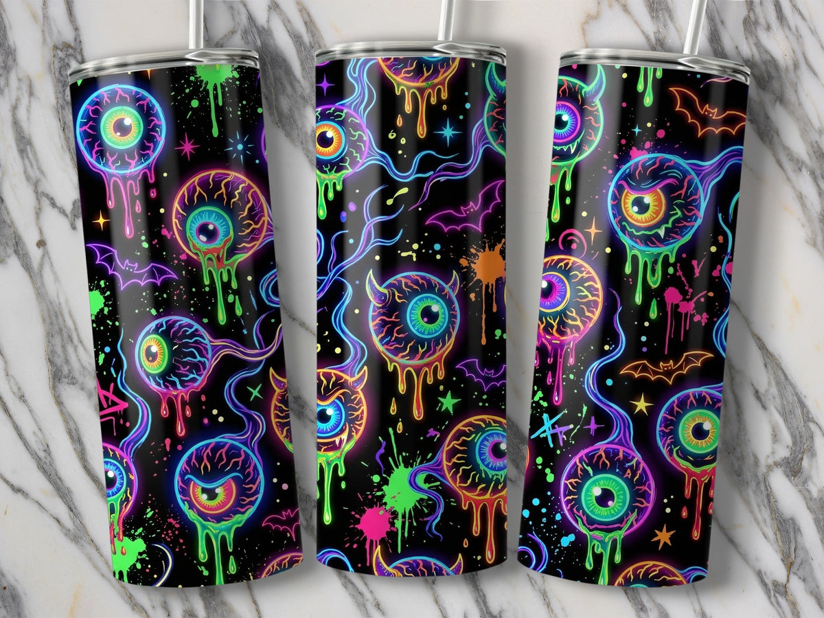 Three tumblers with a neon eyeball and bat Halloween pattern on a marble background.