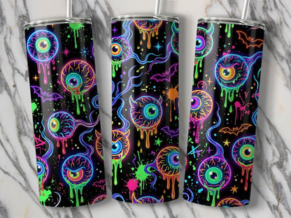 Three tumblers with a neon eyeball and bat Halloween pattern on a marble background.