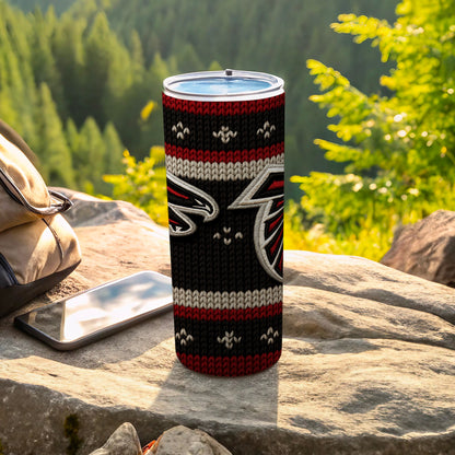 Atlanta Falcons tumbler with knitted design on a rocky outcrop.