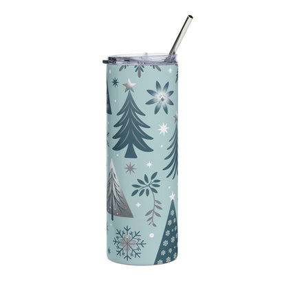 Light blue tumbler with festive trees, snowflakes, and stars pattern and metal straw.