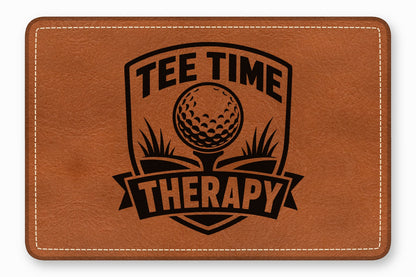 Brown leather patch with rounded corners featuring a black engraved Tee Time Therapy golf crest.