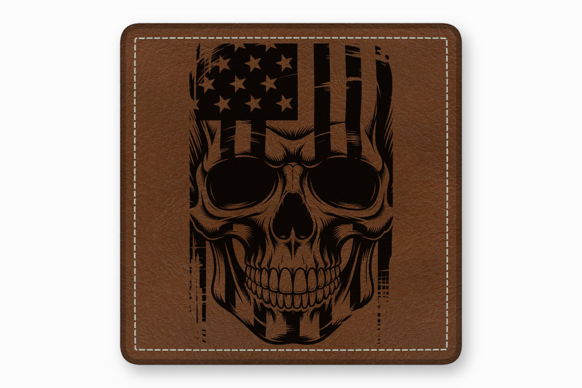 Brown square leather patch with white stitched border featuring a black engraved American flag skull design.