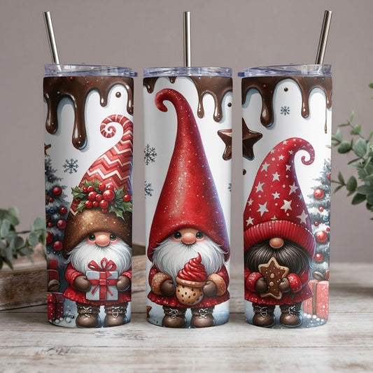 Three gnomes with festive hats, holding gifts and treats, on tumblers with chocolate drips.